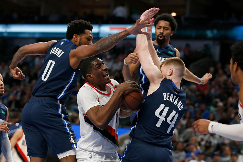 Reggie Perry (10) of the Portland Trail Blazers is guarded by Sterling Brown (0) of the Dallas Mavericks and (44) of the Dallas Mavericks in the first half and at American Airlines Center on April 8, 2022, in Dallas, Texas. (Tim Heitman/Getty Images/TNS)