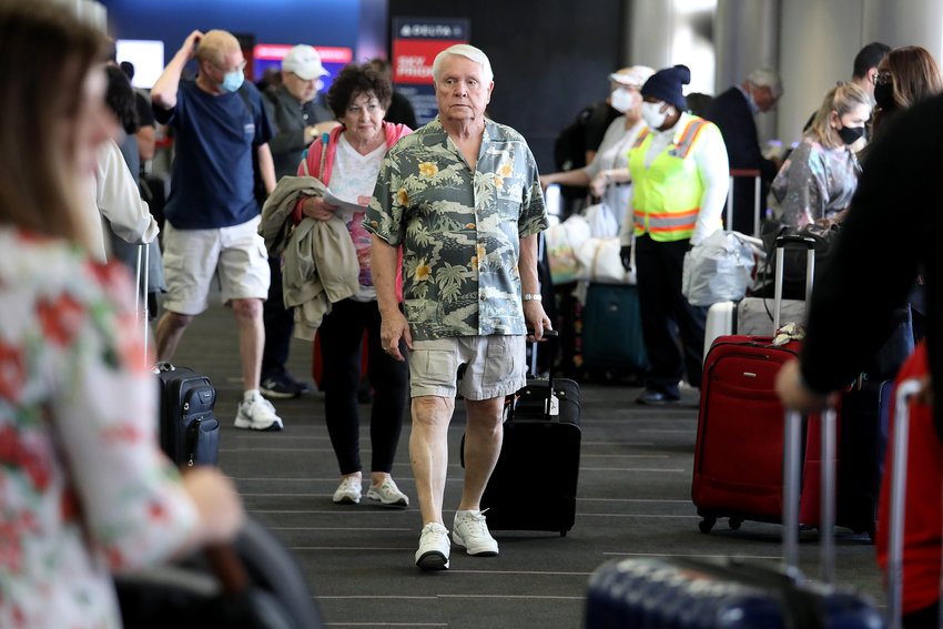 Passengers make their way through Delta Airlines Terminal Two at Los Angeles International Airport on Tuesday, April 19, 2022, in Los Angeles. Airports and airlines dropped their mask requirements after a Florida federal judge voided the Biden administration's mask mandate for planes, trains and buses.