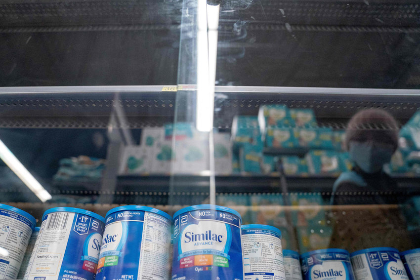 A shopper is reflected in a glass case while looking at baby formula at a grocery store in Washington, D.C., on May 11, 2022. (Stefani Reynolds/AFP via Getty Images/TNS)