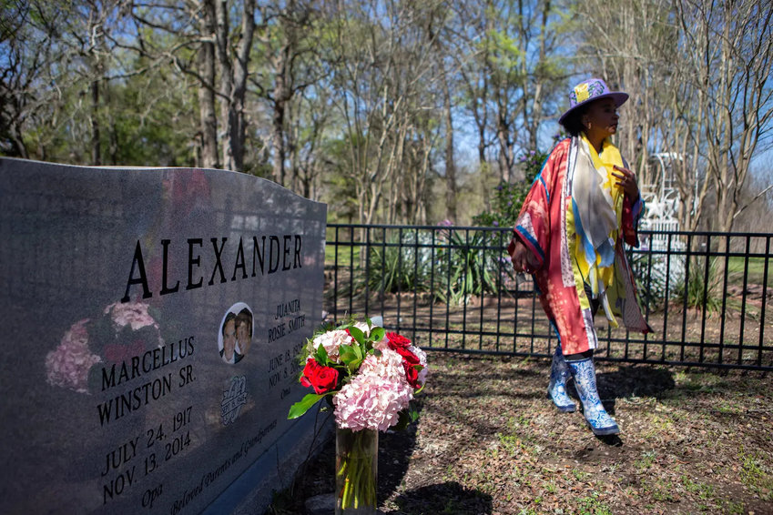 Rosalind Alexander-Kasparik brings flowers to her parents&rsquo; grave at the family cemetery on their land, which has been passed down across several generations. The family is now fighting a highway-widening plan that could call for forcibly buying some of the land.