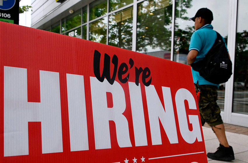 A man walks past a &quot;now hiring&quot; sign posted outside of a restaurant in Arlington, Virginia on June 3, 2022. (Olivier Douliery/AFP via Getty Images/TNS)