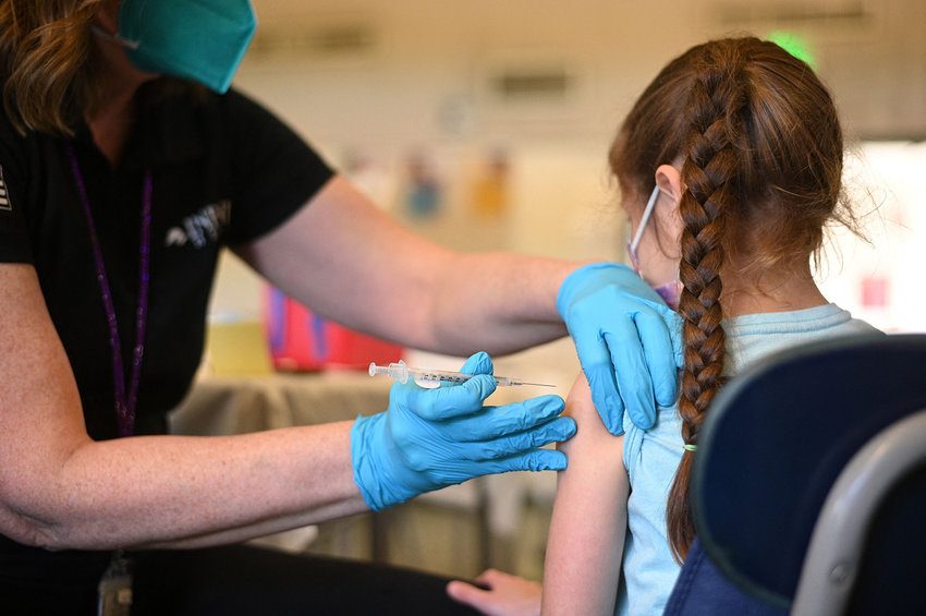 A nurse administers a pediatric dose of the COVID-19 vaccine to a girl at a L.A. Care Health Plan vaccination clinic at Los Angeles Mission College in the Sylmar neighborhood in Los Angeles, California, Jan. 19, 2022.