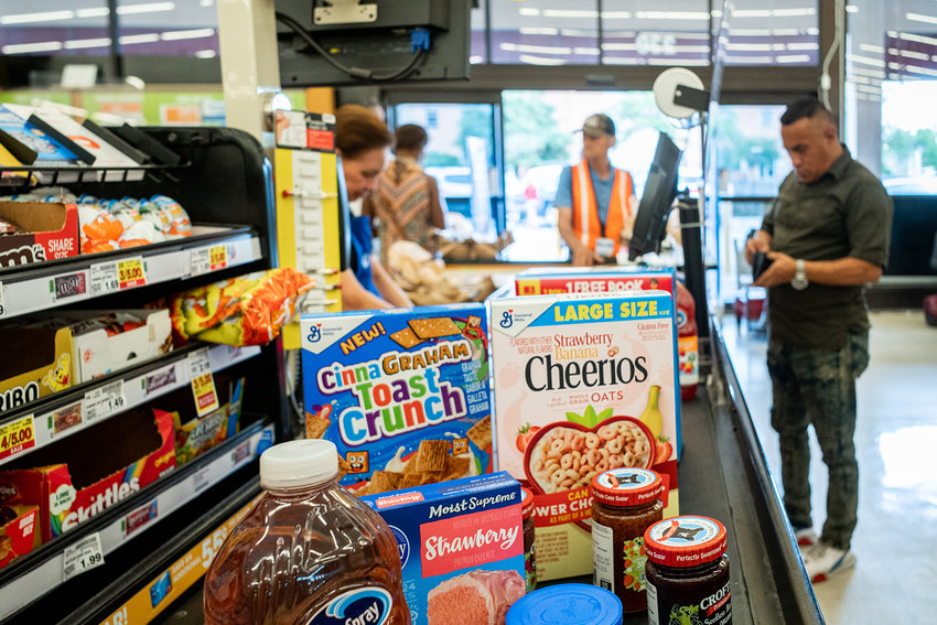 A cashier processes a customer's order in a Kroger grocery store on July 15, 2022, in Houston.