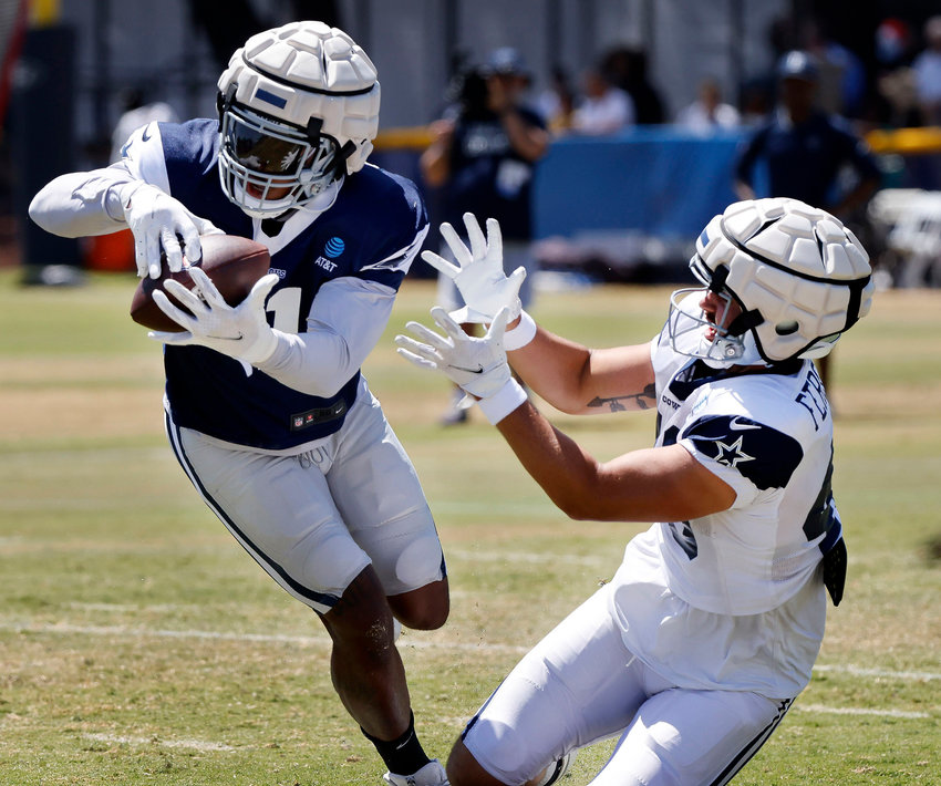 Dallas Cowboys outside linebacker Micah Parsons (11) steps in front of tight end Jake Ferguson (48) for an interception during training camp practice in Oxnard, California, Monday, Aug. 8, 2022.