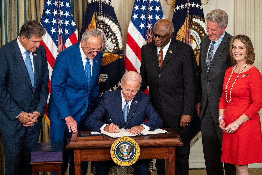 President Joe Biden, flanked by, from left, Sen. Joe Manchin (D-WV), Senate Majority Leader Chuck Schumer (D-NY), House Majority Whip Jim Clyburn (D-SC), Rep. Frank Pallone (D-NJ), and Rep. Kathy Castor (D-FL), delivers remarks and signs the Inflation Reduction Act of 2022 into law in the State Dining Room of the White House on Tuesday, Aug. 16, 2022, in Washington, D.C.