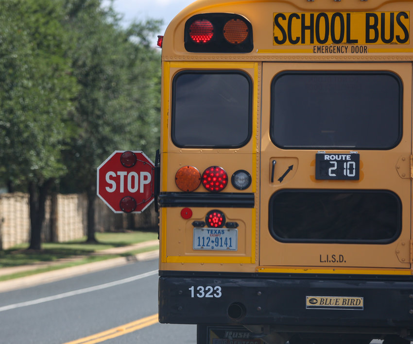 A Leander ISD bus drops children off after school in Cedar Park, Texas on Friday, August 13, 2021.