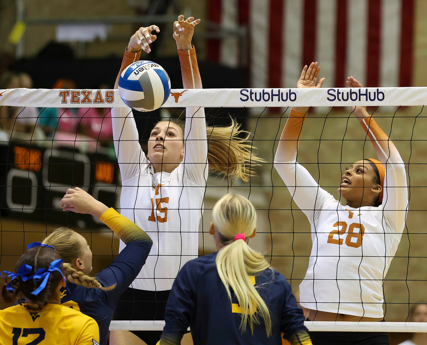 Texas opposite side hitter MOLLY PHILLIPS (15) with a block during an NCAA college volleyball game between Texas and West Virginia on Oct. 22, 2022, in Austin. Texas won 3-0.