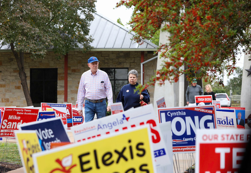 Hundreds of candidate signs line the grounds of the polling place at the Leander Public Library as the poll open on the first day of early voting, Oct. 24, 2022, Leander, Texas.
