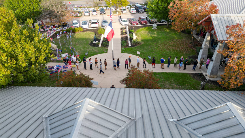 Voters line up to enter the polling place at the Leander Public Library during the late afternoon on Election Day, Nov. 8, 2022, in Leander, Texas. The 5 p.m. to 6 p.m. hour was the busiest across Williamson County, where more than 57,000 voters cast a ballot on Election Day, bringing the total including early voting to over 213,000 and a turnout of more than 51%.