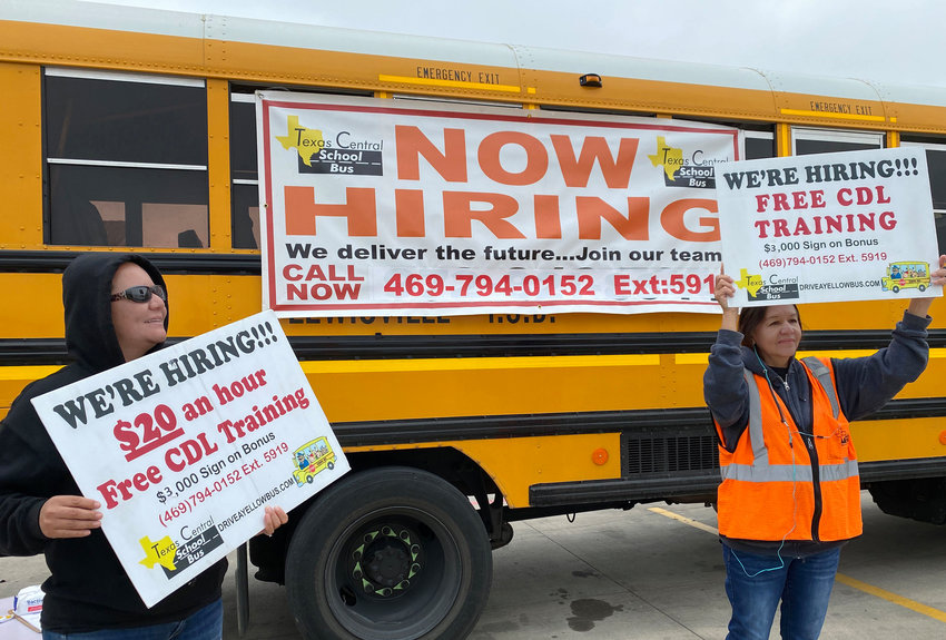 With low unemployment and over 1 million job openings in Texas, companies say they can't find enough workers. Earlier this year, school bus drivers Salomae Arebalos, left, and Flo Lopez tried to recruit bus drivers and monitors in the Dallas area.