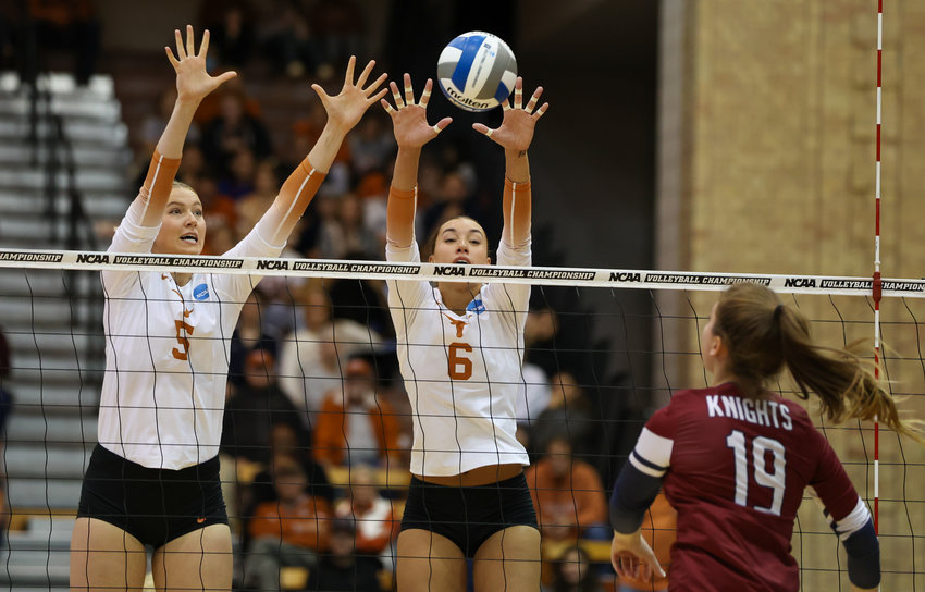 Texas middle blocker BELLA BERGMARK (5) and outside hitter MADISEN SKINNER (6) go up to block during a first-round match between Texas and Fairleigh Dickinson in the NCAA volleyball tournament on Dec. 1, 2022 in Austin, Texas. Texas won, 3-0.