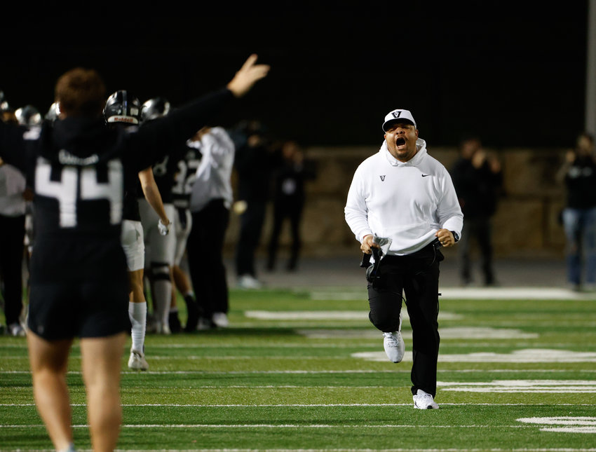 Vandegrift defensive line coach Nate Griffin reacts in celebration after a goal line stand and fumble recovery during a high school football playoff game between Vandegrift and Dripping Springs on Dec. 2, 2022, in Austin.