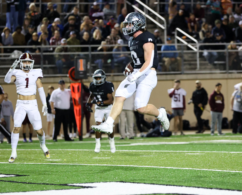 Vandegrift senior running back Alex Witt (0) leaps over the goal line on a touchdown run during a high school football playoff game between Vandegrift and Dripping Springs on Dec. 2, 2022, in Austin.