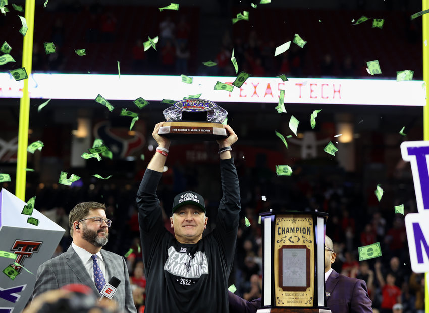 Texas Tech head coach Joey McGuire holds the TaxAct Texas Bowl champions trophy after beating Ole Miss 42-25, on Dec. 28, 2022 in Houston.