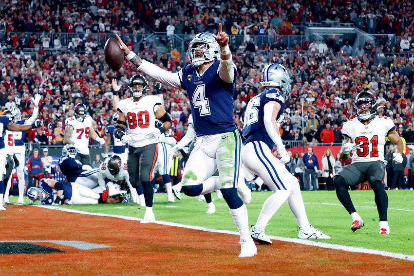 Dak Prescott (4) of the Dallas Cowboys rushes for a touchdown against the Tampa Bay Buccaneers during the second quarter in the NFC Wild Card playoff game at Raymond James Stadium on January 16, 2023, in Tampa, Florida. (Mike Ehrmann/Getty Images/TNS)