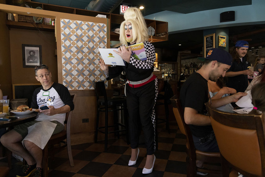 Ginger Forest reads &ldquo;Going Places&rdquo; during story time with drag queens during brunch at a restaurant in the Chicago area last year.