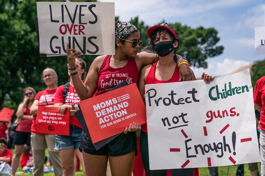 Raquel Gabin (left) hugs her mother Joseline Castanos while listening to speakers during the Moms Demand Action Gun Violence Rally on June 8, 2022, in Washington, D.C.