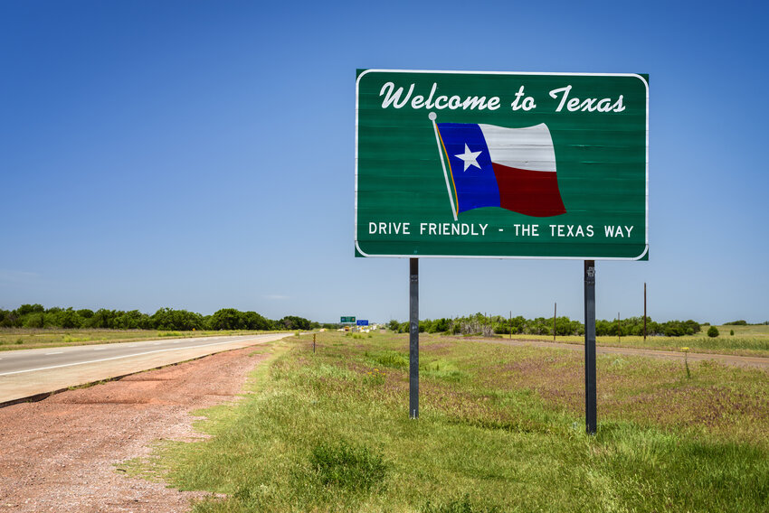 A &quot;Welcome to Texas&quot; sign greets drivers as they enter the Lone Star State on U.S. 75 near Denison. In a survey of where $100,000 in salary goes furthest, seven of the top 10 cities were in Texas, a famously low-tax state.