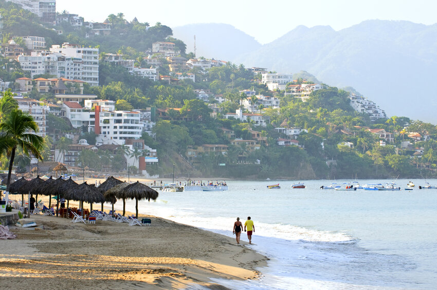 Tourists take a walk on the beach at Puerto Vallarta, Mexico. Only 48% of U.S. workers say they use all their vacation days, according to a new survey from Pew Research Center.