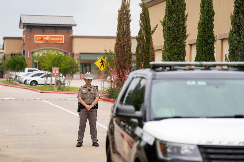 A Texas DPS trooper blocks an entrance to the mall parking lot a day after a mass shooting at Allen Premium Outlets on Sunday, May 7, in Allen, Texas.