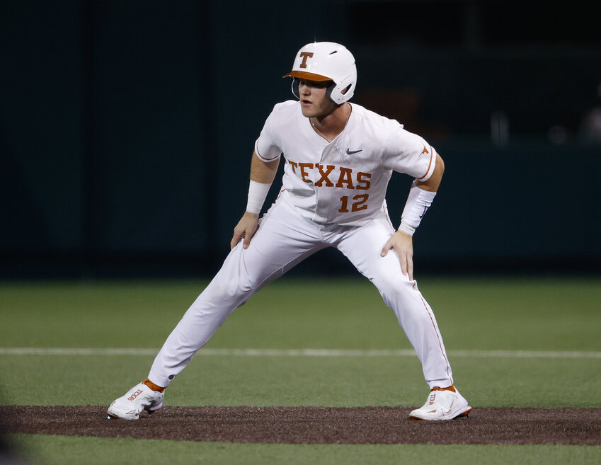 Texas outfielder Max Belyeu (12) gets a lead off first base during an NCAA college baseball game between Texas and LSU on Feb. 28, 2023, in Austin.
