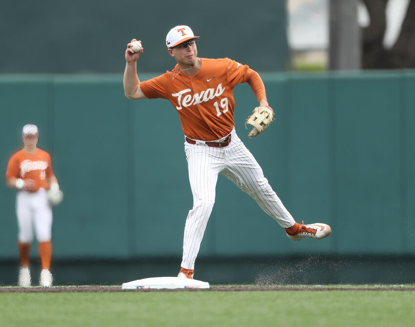 Texas second baseman Mitchell Daly (19) throws to first after fielding a short chopper during an NCAA baseball game against TCU on April 10, 2022 in Austin, Texas. Texas won, 7-3, taking the series two games to one.