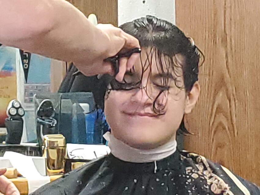 Justin Kelly, a 15-year-old percussionist in the Cedar Park High School band, donates his hair on June 28 to the nonprofit Locks of Love, which makes custom-made hair prosthetics for people who suffered hair loss due to medical conditions.