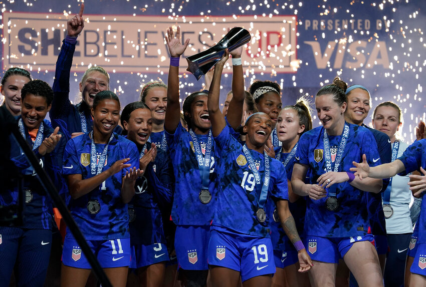The United States' Crystal Dunn (19) hoists the trophy with her teammates after defeating Brazil in the SheBelieves Cup final at Toyota Stadium on Feb. 22, 2023, in Frisco, Texas. (Sam Hodde/Getty Images/TNS)