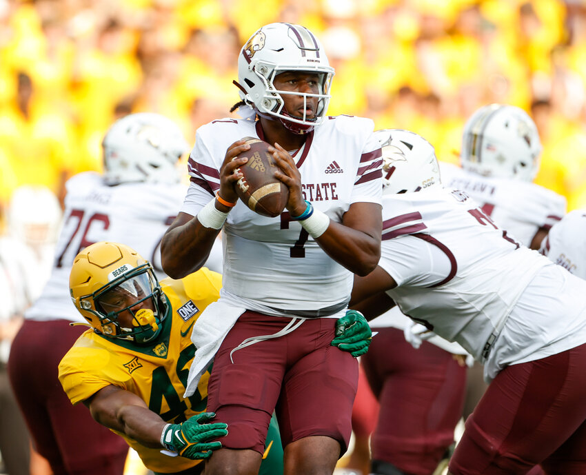 Texas State quarterback TJ Finley (7) looks to pass the ball as Texas State safety Justin Strong (40) grabs on for an attempted sack during an NCAA football game between Baylor and Texas State on September 2, 2023 in Waco, Texas. Texas State won, 42-31.