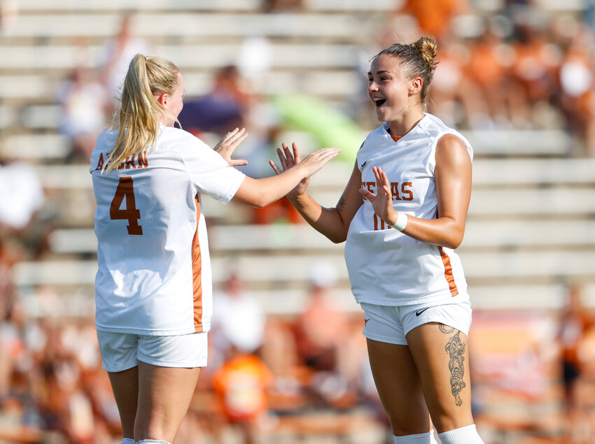 Texas forward Liz Worden (12) celebrates with midfielder Olivia Ahern (4) after a goal during an NCAA women&rsquo;s soccer match between Texas and SMU on September 3, 2020 in Austin. Texas won, 6-0.