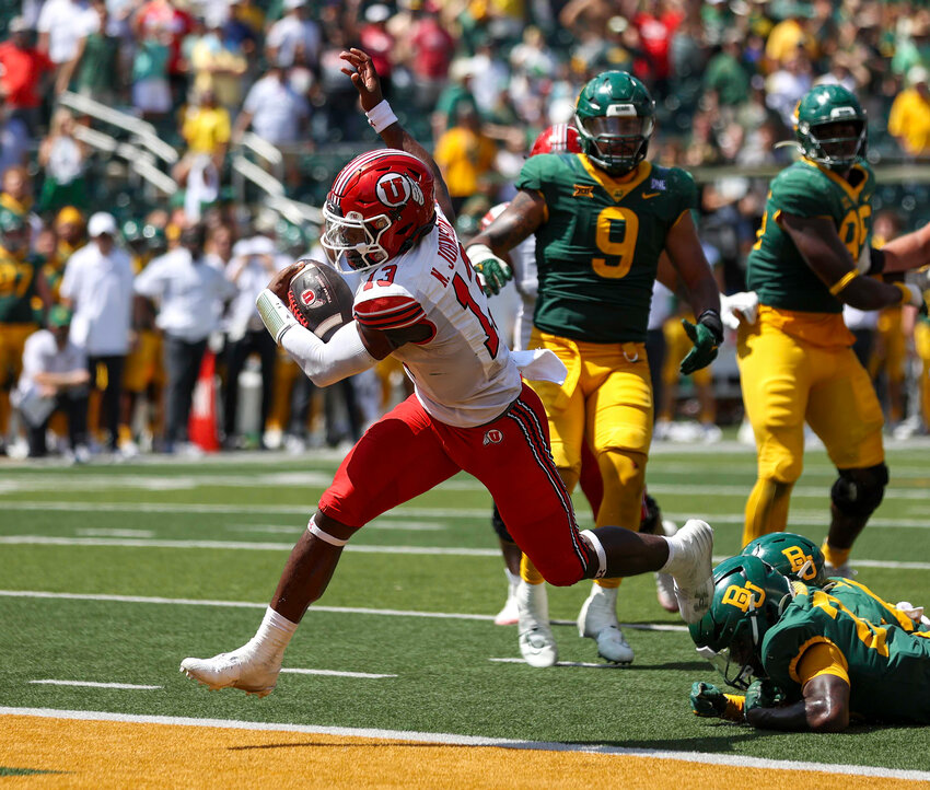 Utah quarterback Nate Johnson (13) scores on a 7-yard touchdown run during an NCAA football game between Baylor and Utah on September 9, 2023 in Waco, Texas. Utah won, 20-13.