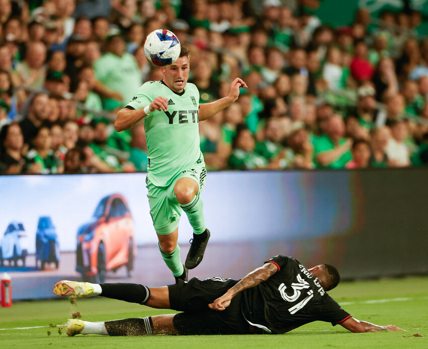 D.C. United defender &Eacute;ric Davis (31) makes a tackle on Austin FC midfielder Ethan Finlay (13) during a Major League Soccer match on October 4, 2023 in Austin.