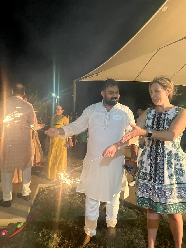 Leander Mayor Christine DeLisle (right) attends a private Diwali celebration back in October 2022 with its organizer, Vedant Garg (center left).