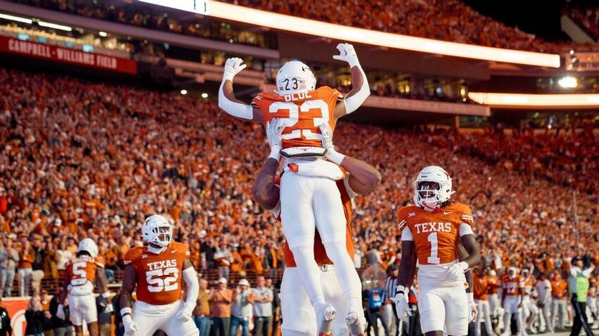 Teammates celebrate with Texas sophomore running back Jaydon Blue (23) after a touchdown in the Longhorns' 57-7 win over Texas Tech at DKR-Texas Memorial Stadium last Saturday.