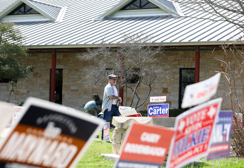 A voter leaves the polling place at the Leander Public Library during early voting on February 26, 2024.