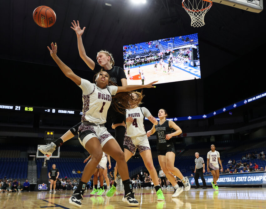 Timberview Wolves guard Kamryn Wilson (1) and Cedar Park Timberwolves forward Kennedy Carlyle (4) reach for a rebound during the Class 5A girls state semifinal basketball game on February 29, 2024 in San Antonio. Timberview won, 67-45.