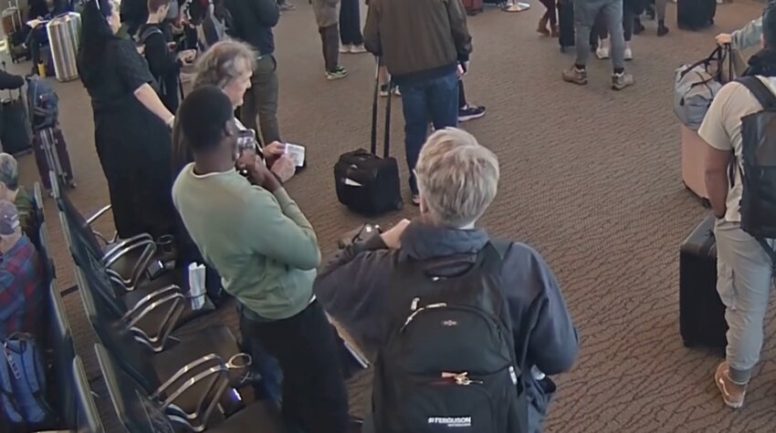 Video released by the Salt Lake City Department of Airports allegedly shows Wicliff Fleurizard taking photographs of another passenger's boarding pass before illegally using it on March 17 to sneak on an airplane.