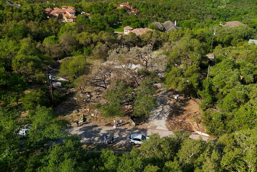 People look over the devastation the day after a two-story home in Northwest Austin was leveled by what officials say was a "substantial propane gas leak" in the recently-built home.