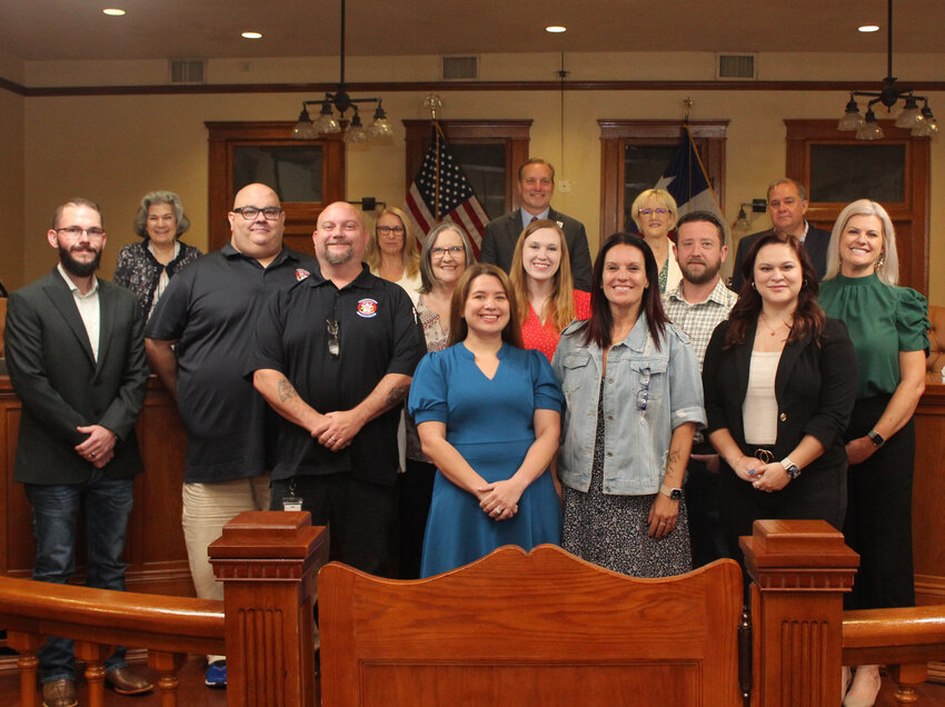 Back row, from left: Terry Cook, Precinct 1 commissioner; Cynthia Long, Precinct 2 commissioner; Steve Snell, county judge; Valerie Covey, Precinct 3 commissioner; Russ Boles, Precinct 4 commissioner. Middle row, from left: Michael Moody, public safety technology manager; Stephn Biasatti, QAQI evaluator; Terri Stubblefield, QAQI supervisor; Victoria Edwards, academy instructor; James Bodisch, training division manager; and Mary Daniels, compliance division manager. Front row, from left: Stephen Hollis, deputy director; Rebeca Christiansen, QAQI evaluator; Katherine Wolf, director; and Lexi Wood, instructional coordinator.