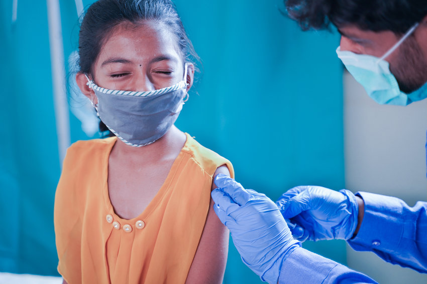 A child getting a COVID-19 vaccine