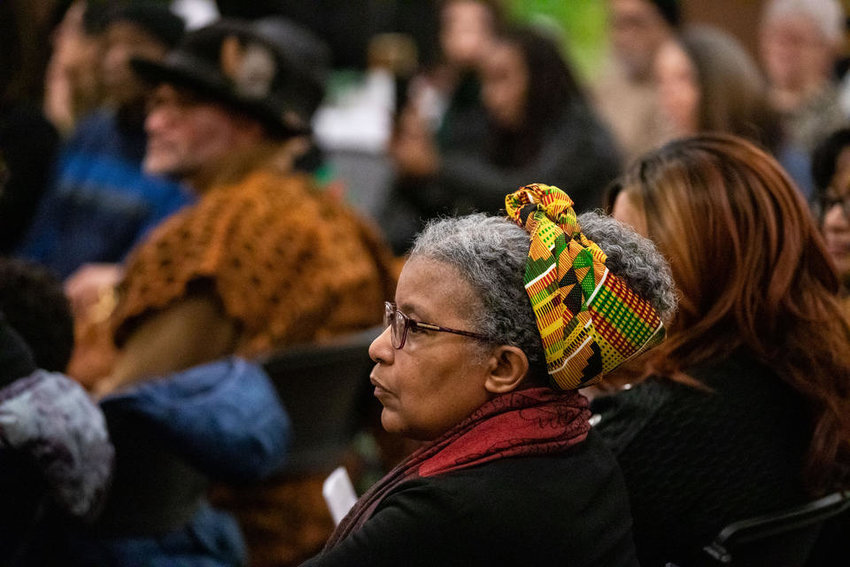 The audience listens to spoken word artist Tia Naché perform at Northwest African American Museum’s Kwanzaa event at Washington Hall on Thursday, Dec. 29, 2022. (Amanda Snyder/Crosscut)