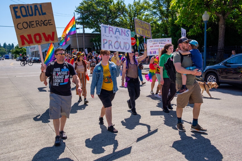 Some of the Pride Day marchers carried signs, such as those that read, "Same Treatment, Different Coverage?" and "Trans and Proud" on Saturday, July 1, 2023.