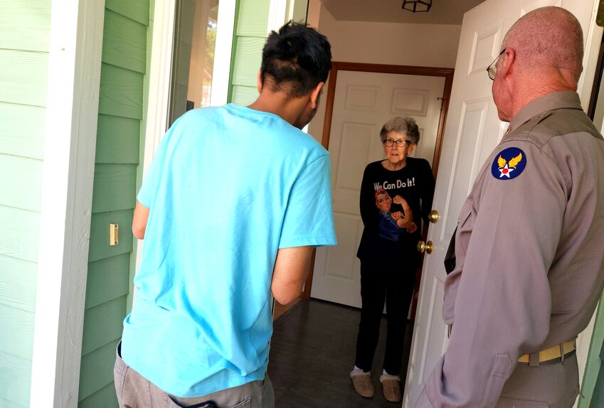 Doris Bier greets Rishi Sharma and Dave Gaston at her front door. July 3, 2023.