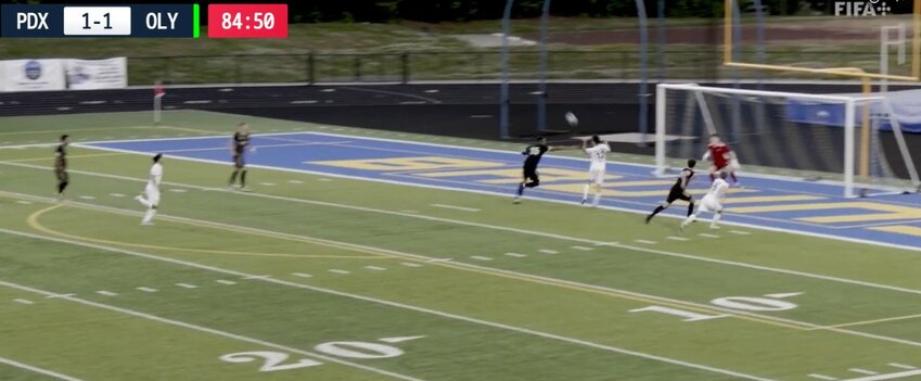An unmarked Cooper Brunell (white jersey at #12) receives this free header from a cross to give the lead to Oly Town FC.