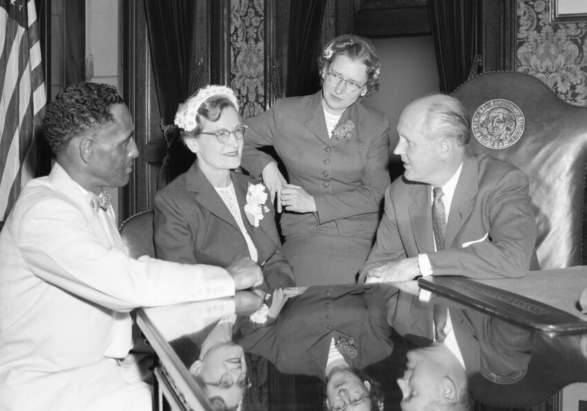 Gladys Burns (third from the left) with Governor Arthur B. Langlie (far right) in his office with two other people, names unrecorded. Source: Susan Parish Photograph Collection, 1889-1990, WASHINGTON STATE ARCHIVES.