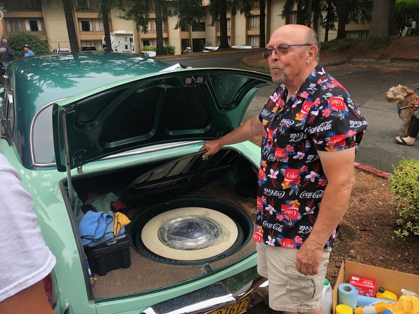 Jim Koch ("coke," get it?) shows off the original spare tire that hides under the carpeted trunk of his 1952 Kaiser Manhattan.