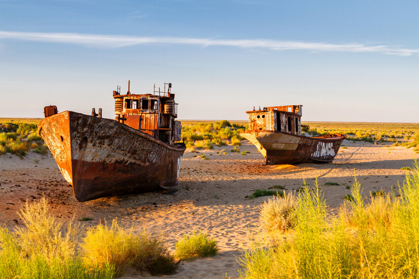Rusted boats in the desert that used to be the Aral Sea - Uzbekistan, Central Asia.
