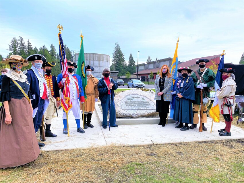 Diane Smith (far left) at the dedication of her project to honor the Thurston County women who voted in the 1870 election. Immediately left of the stone is Washington State Representative Laurie Dolan, 22nd legislative district, and immediately to the right of the stone is Secretary of State Kim Wyman.