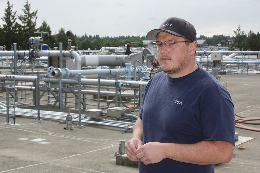 Matt Valenta, operations manager of the LOTT Water Alliance's sewage treatment plant, explains how nutrients are removed from waste water. The four governments that make up LOTT, Lacey, Olympia, Tumwater, Thurston,  jointly own and operate the plant through a non-profit corporation. (John Stang for Crosscut)