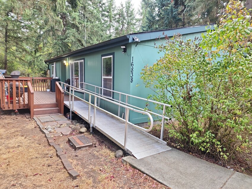 Darin owns a well-designed manufactured home, built in 2006. Here you can see the concrete ramp installed by the American Legion #164 in Yelm. SPSHH will soon install a wider front door, to better accommodate an electric wheelchair.  Sept. 10, 2023.
